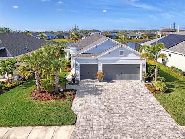 view of front facade with a front yard and a garage