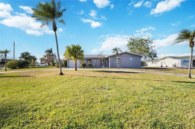 view of front of property with a front yard and a garage