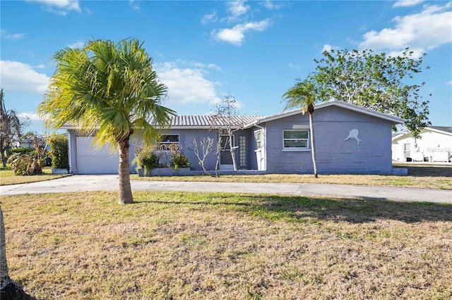 single story home featuring a garage and a front yard