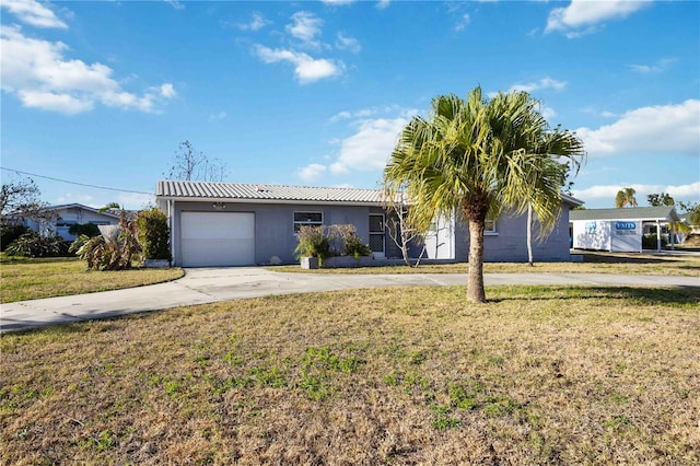 single story home featuring a front yard and a garage