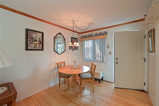 dining room featuring light hardwood / wood-style floors, crown molding, and a chandelier