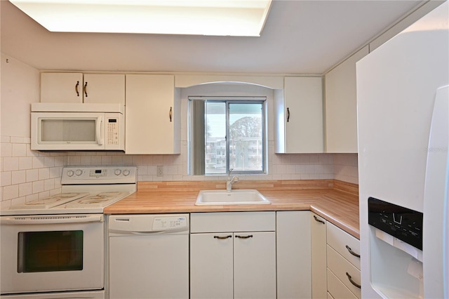 kitchen featuring backsplash, white cabinetry, white appliances, and sink