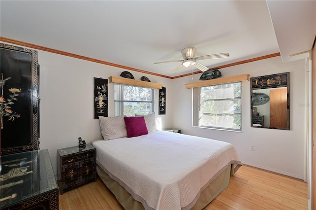 bedroom with ceiling fan, light hardwood / wood-style flooring, and ornamental molding