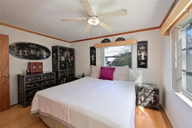 bedroom with ceiling fan, crown molding, and light hardwood / wood-style floors