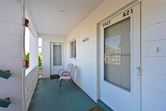 view of exterior entry featuring a porch