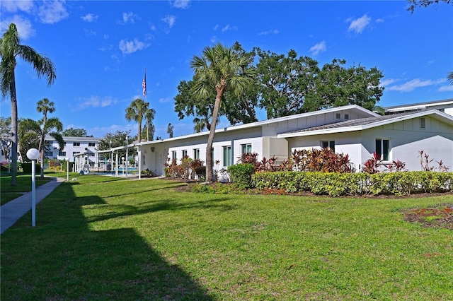 ranch-style home with a front lawn