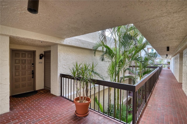 view of exterior entry featuring a balcony