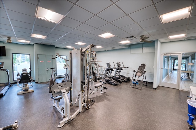 gym with ceiling fan and a drop ceiling