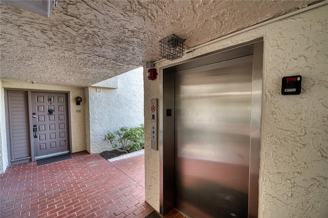 entrance to property featuring elevator