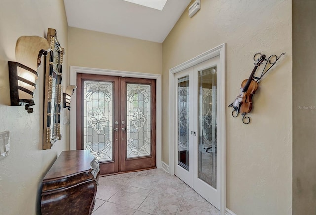 entrance foyer with french doors and light tile patterned floors