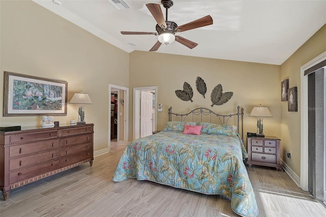 bedroom featuring a walk in closet, ceiling fan, and a closet