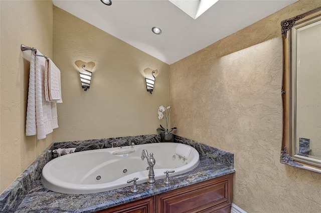 bathroom with a bathing tub and vaulted ceiling