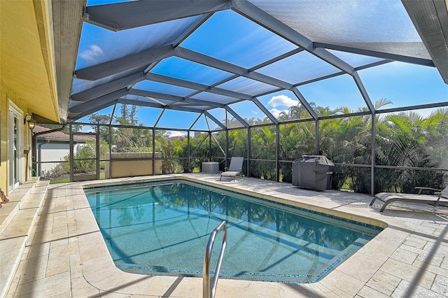 view of swimming pool with a lanai and a patio area