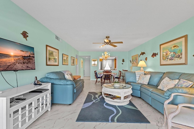 living room with ceiling fan with notable chandelier