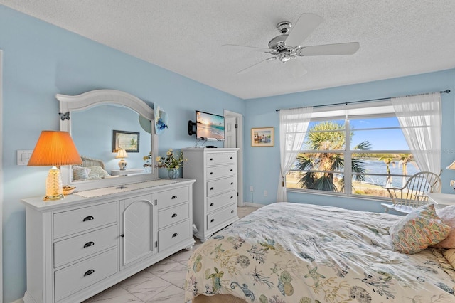 bedroom featuring a textured ceiling and ceiling fan