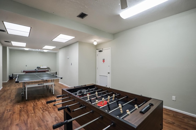 game room with dark hardwood / wood-style floors