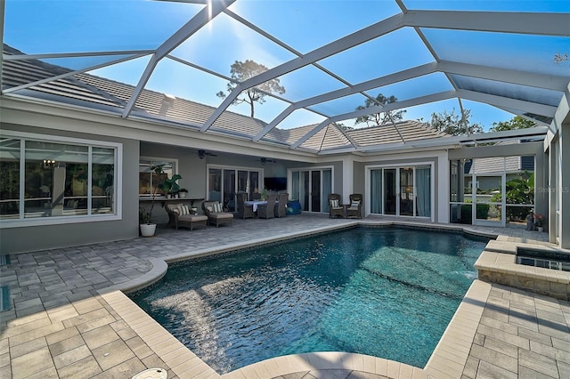 view of pool with ceiling fan, a patio area, and glass enclosure