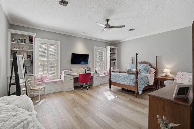 bedroom featuring ceiling fan, light hardwood / wood-style flooring, a textured ceiling, and ornamental molding