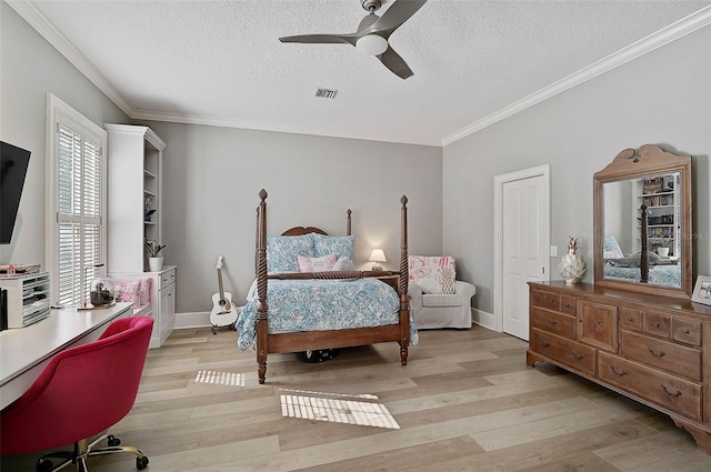 bedroom with ceiling fan, crown molding, light hardwood / wood-style floors, and a textured ceiling