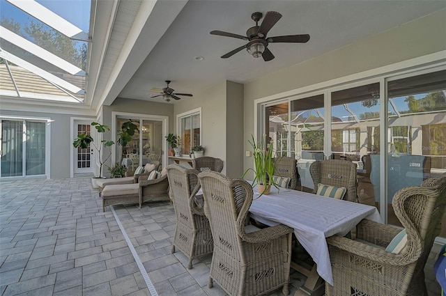 view of patio / terrace with ceiling fan and glass enclosure