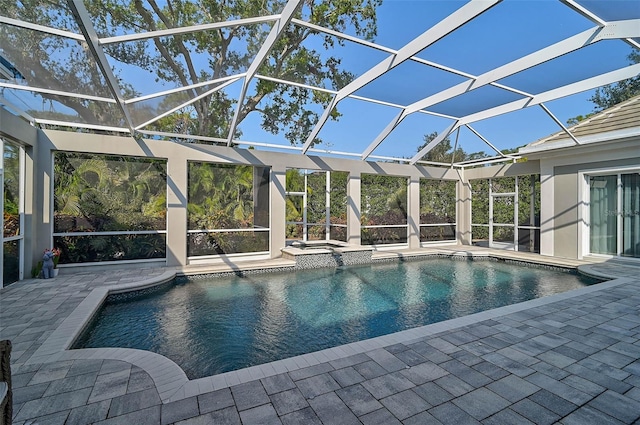 view of swimming pool with a patio area and a lanai