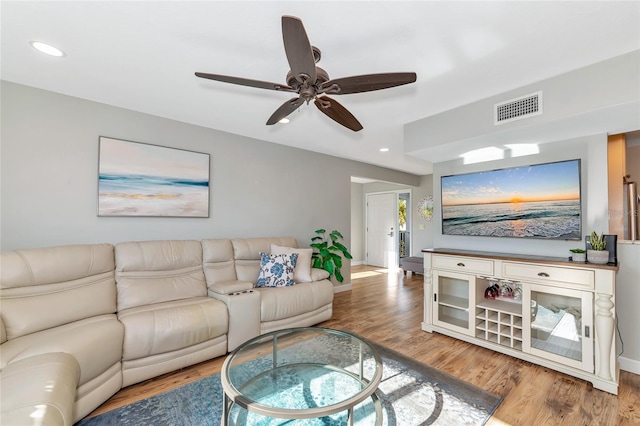 living room with ceiling fan and wood-type flooring