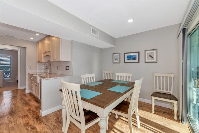 dining space featuring sink and light hardwood / wood-style floors