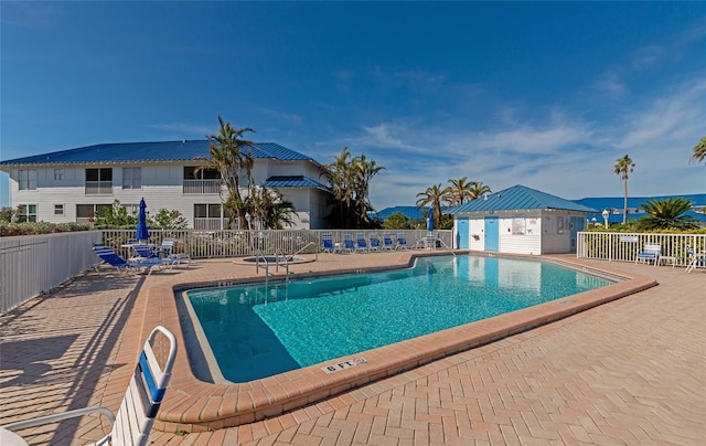 view of swimming pool with a patio area and an outdoor structure