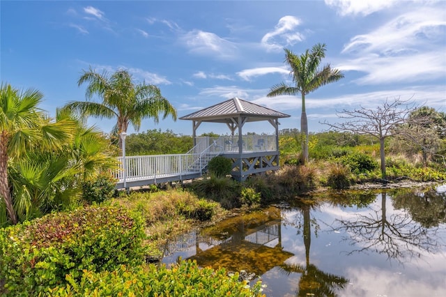 surrounding community with a gazebo and a water view