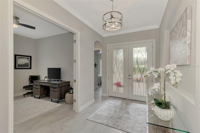 foyer entrance featuring crown molding, french doors, ceiling fan with notable chandelier, and light hardwood / wood-style flooring