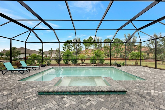 view of swimming pool featuring glass enclosure, a patio area, and an in ground hot tub