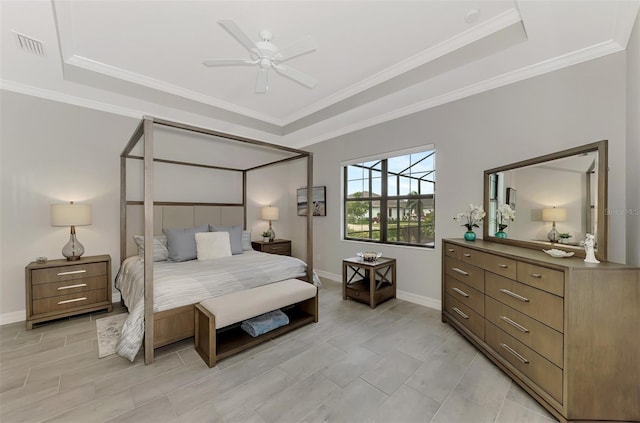 bedroom with a tray ceiling, ceiling fan, and crown molding