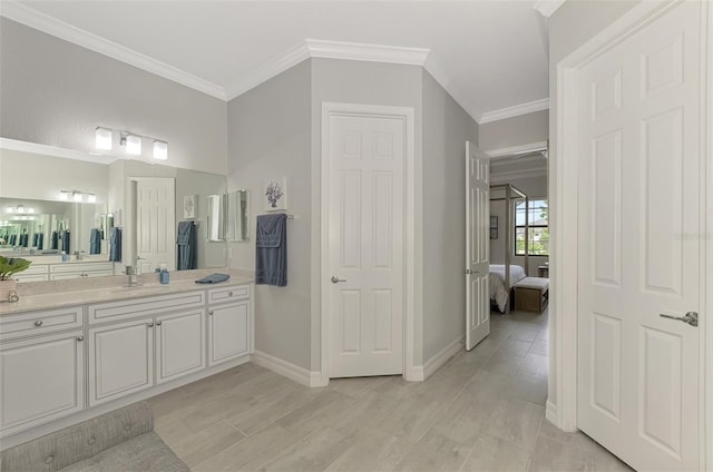 bathroom with hardwood / wood-style floors, vanity, and crown molding