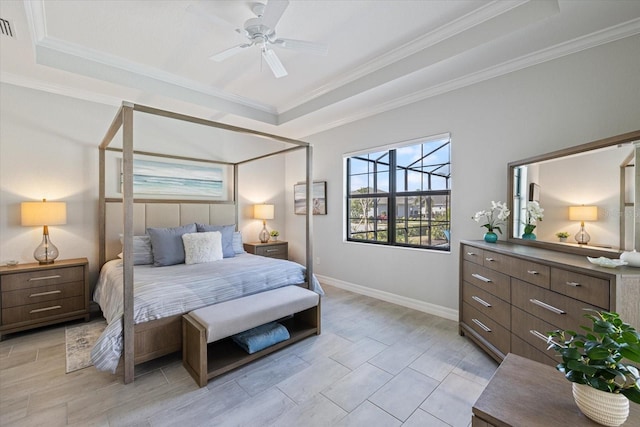 bedroom featuring baseboards, a raised ceiling, visible vents, and crown molding