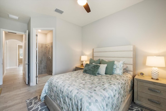 bedroom with arched walkways, a ceiling fan, baseboards, visible vents, and light wood-style floors