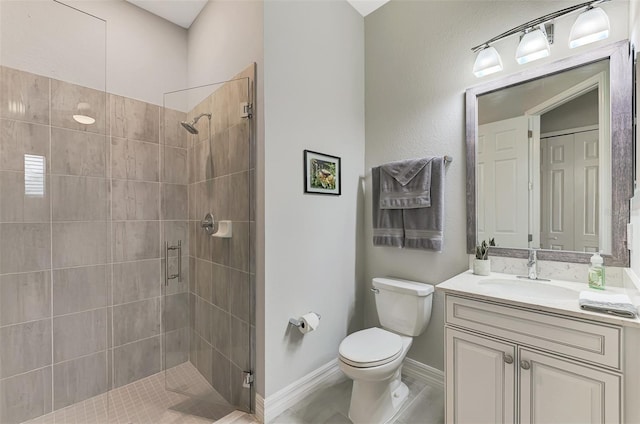 bathroom with toilet, a stall shower, baseboards, and vanity