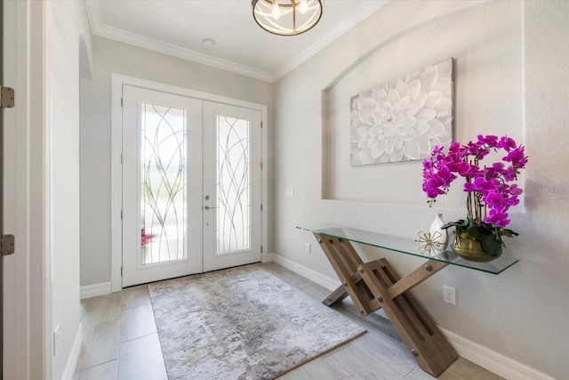 foyer entrance with baseboards, french doors, and crown molding