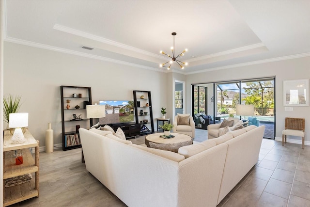 living area featuring baseboards, a raised ceiling, visible vents, and an inviting chandelier