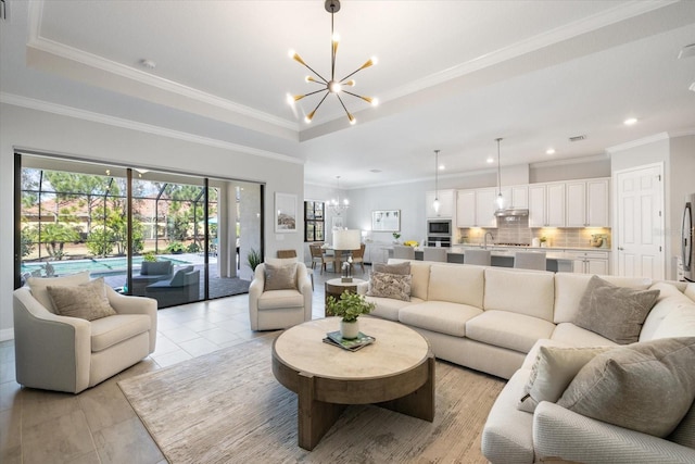 living room featuring ornamental molding, recessed lighting, a raised ceiling, and an inviting chandelier