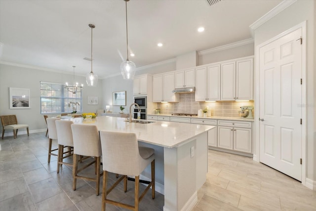 kitchen with backsplash, ornamental molding, stainless steel appliances, and a sink