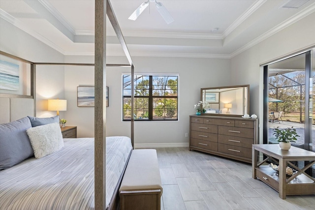 bedroom with multiple windows, visible vents, a raised ceiling, and crown molding