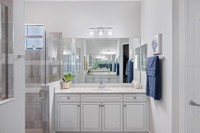 full bathroom with a stall shower and vanity