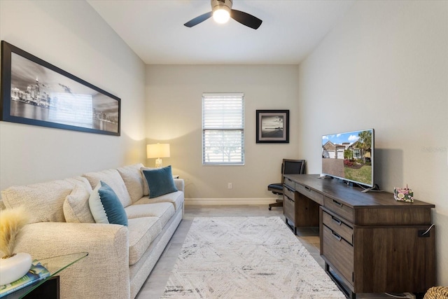 office space featuring a ceiling fan and baseboards