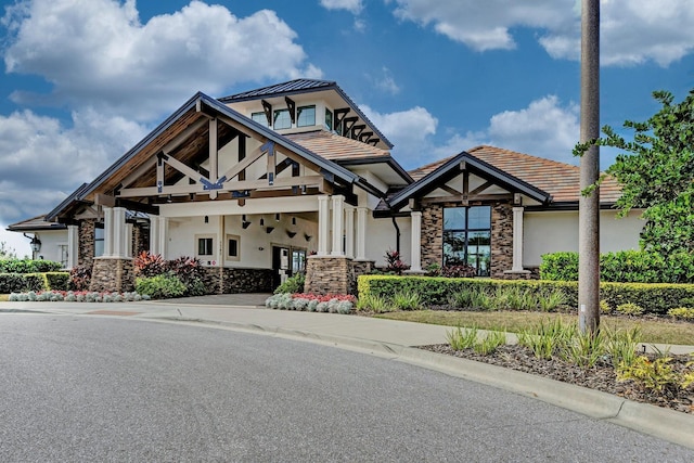 view of front of property featuring stone siding and stucco siding