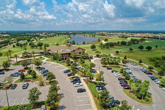 birds eye view of property featuring golf course view and a water view