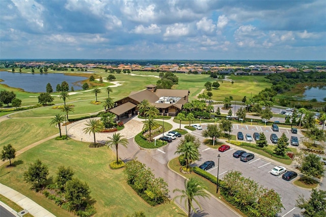 bird's eye view with a water view and view of golf course