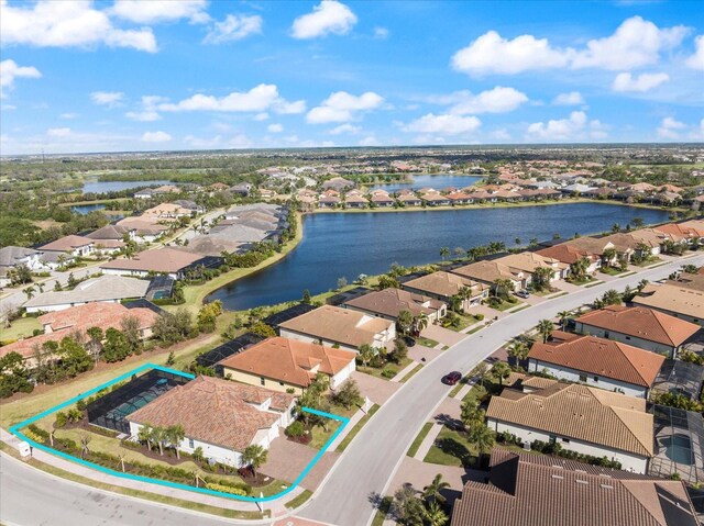 drone / aerial view featuring a water view and a residential view