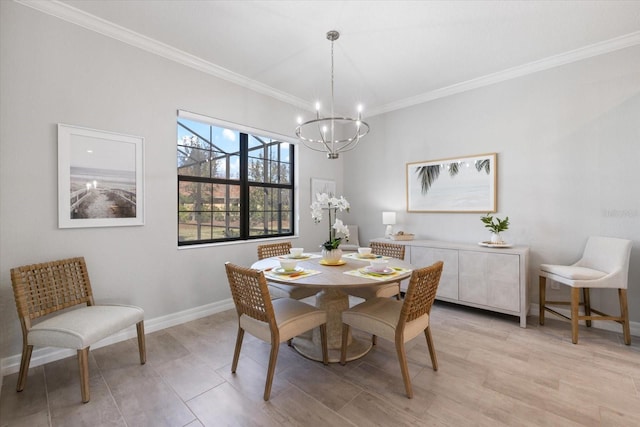 dining room with crown molding, a notable chandelier, and baseboards