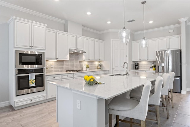 7130 Whittlebury Trl, Bradenton, FL 34202 - kitchen featuring stainless steel appliances, a sink, white cabinetry, backsplash, and recessed lighting