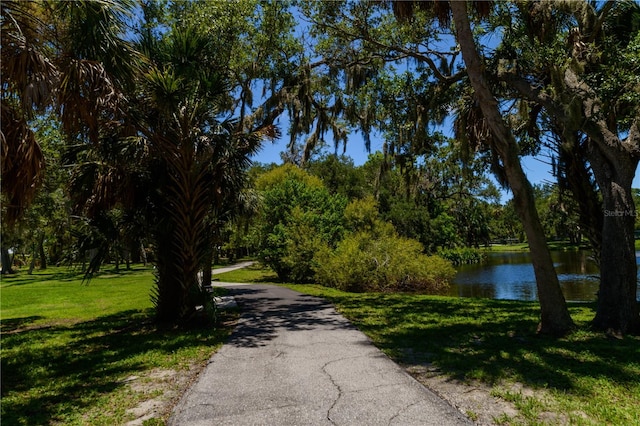 surrounding community with a lawn and a water view